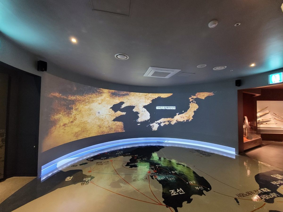 Memorial hall gallery with a map of the Korean Peninsula projected on a curved wall and the floor