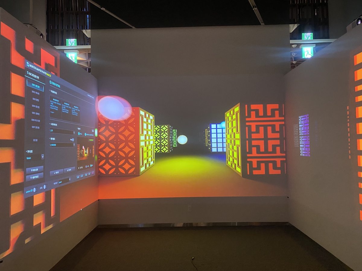 Exhibition hall with traditional pattern video projected on both corridor walls and the front wall