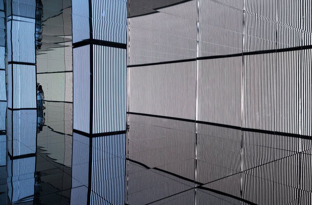 Space where LED panels on several sides play the same striped video in sync