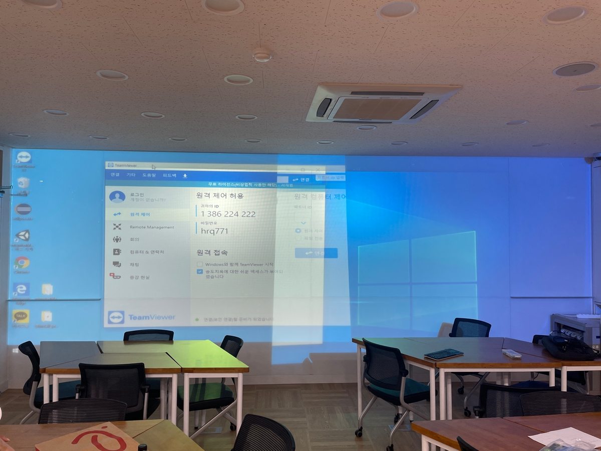 University lecture room with the Windows desktop shown across the entire front wall